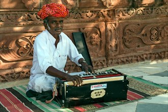 Indians man with a harmonium
