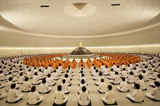Monks meditating in the Phramonkolthepmuni meditation hall