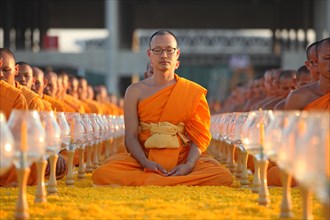Monks sitting in a row meditating