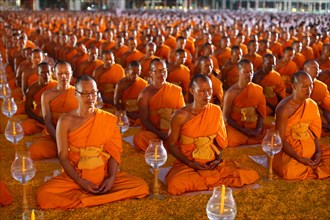 Monks sitting in a row meditating