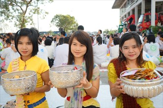 Young women collect donations at the Bigboon pilgrims' procession