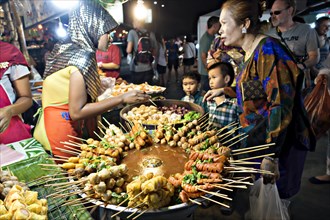 Stall with a large pot with skewers