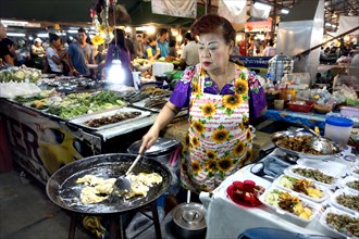 Woman preparing food in a large pan