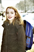 School girl with school bag on her way to school