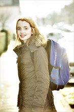 School girl with school bag on her way to school