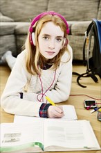 Girl with headphones doing homework
