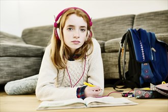 Girl with headphones doing homework