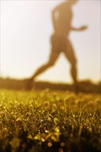 Jogger running in grass