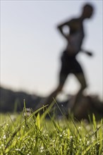 Jogger running in grass