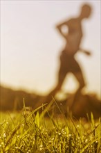 Jogger running in grass