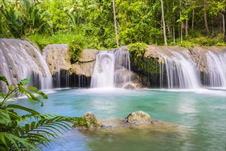 Cambugahay Falls surrounded by jungle foliage