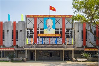 Portrait of Ho Chi Minh and Vietnamese flag on a government building