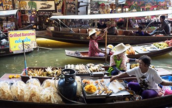 Floating Market with boats and sellers on a canal or Khlong