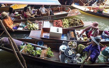Floating Market with boats and sellers on a canal or Khlong