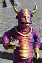 Horned creature with coffee cup