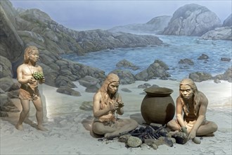Indigenous people at a fire place on the coast