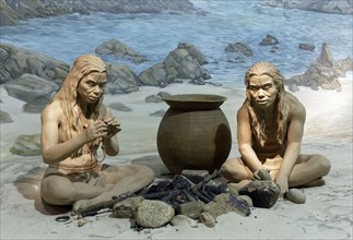 Indigenous people at a fire place on the coast