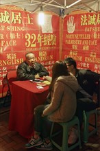 Chinese soothsayers in a lit tent