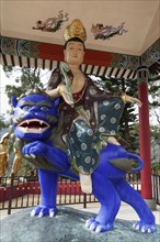 Buddhist figure Manjushri or Wen Shu sitting on a blue lion