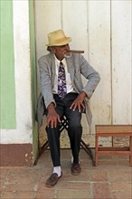 Elderly Cuban man with a large cigar entertaining the tourists