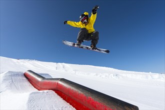 Snowboarder jumping in the park