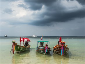Colourful long-tail boats in turquoise sea