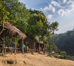 People sitting in front of wooden huts