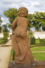 Putto from behind in the convent garden