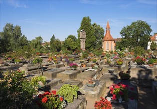 Old graves at the St. Johannis cemetery with St. John's Church