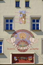 Coat of arms and sundial on facade
