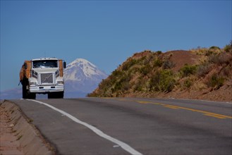 Truck on the road in front of the Sajama volcano