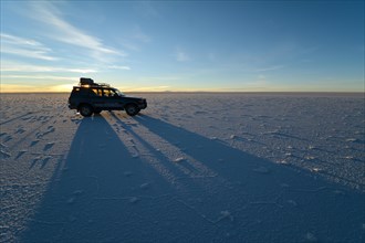 SUV shadow on salt flat