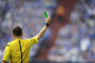 Referee holding green card