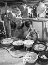 Thai woman washing dishes and pots
