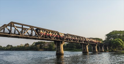 Train crossing the historical River Kwai Bridge