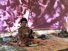 Orang Asil woman sitting in a tent in the jungle