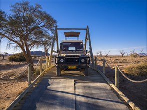 Land Rover crossing a wooden bridge in the Kulala Wilderness Reserve on the edge of the Namib Desert