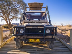 Land Rover crossing a wooden bridge in the Kulala Wilderness Reserve on the edge of the Namib Desert