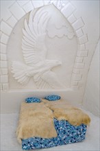 Bedroom with wall decoration relief of an eagle in the ice hotel