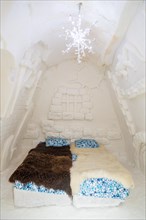 Bedroom with wall decoration in the ice hotel