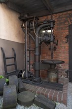 Machine with drive belt of the former iron hammer mill