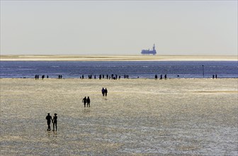 Strollers walking at low tide on the foreshore