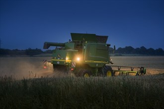 Combine harvester harvesting at night