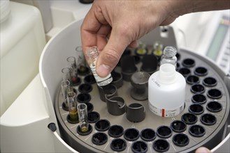 Filling a centrifuge in a medical laboratory