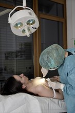 Patient and dermatologist during surgery