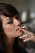 Young woman smoking in a bar or bistro