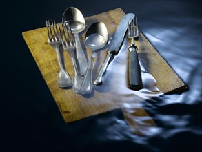 Cutlery on a board under water
