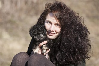 Woman holding Toy Poodle
