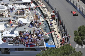 Viewers on yachts in Port Hercule at the track