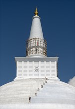 A group of climbers paint Ruwanwelisaya or Ruwanweli Maha Seya Stupa